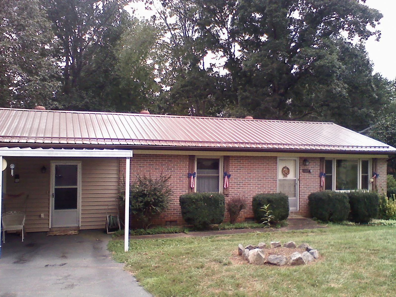 Bronze metal roof and carport on a brick ranch home — Roof Repair work by our crew in Hope
